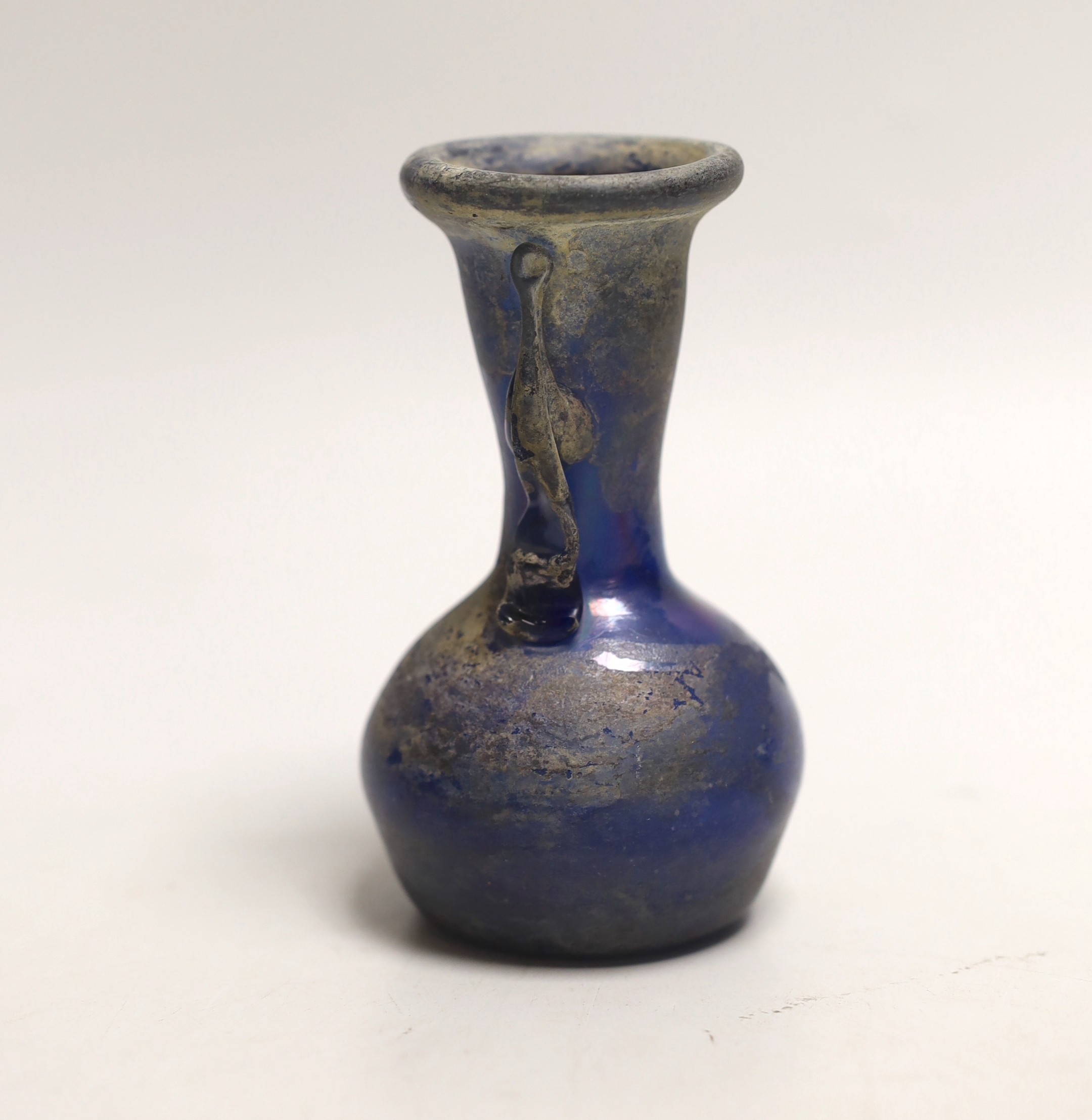 An 8th/9th century Islamic blue glass vase, 12cm